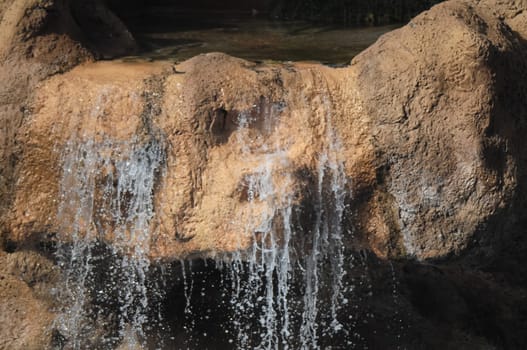 Small River Waterfall Between some Brown Rocks