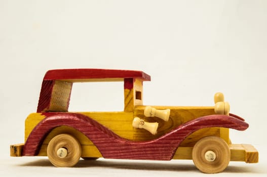 Wooden Toy Red and Yellow Car on a white Backgraund
