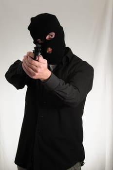 Black Dressed Young Man Holding a Pistol Gun