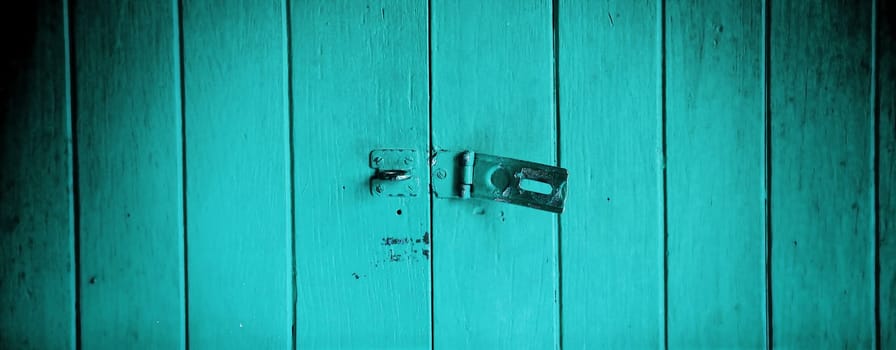 Old padlock on a red wooden door