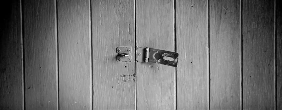 Old padlock on a red wooden door
