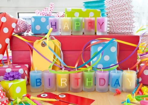 Happy Birthday written on colorful candles and gifts