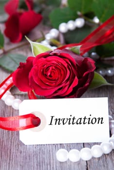 Label with Invitation and Roses as Background