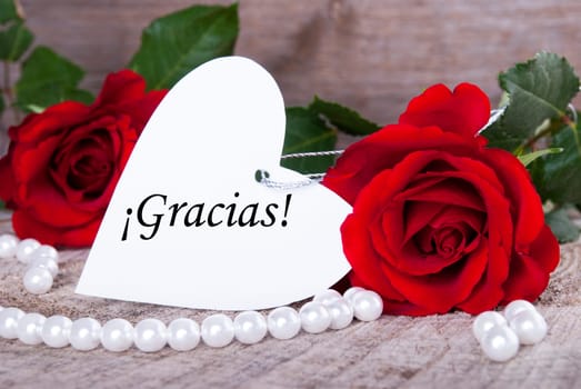 Background with Roses and Pearls and the Spanish word Gracias which means Thanks