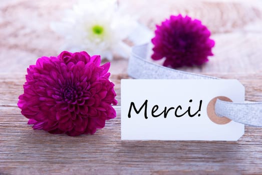 Label with the French Word Merci which means Thanks and Purple Flowers