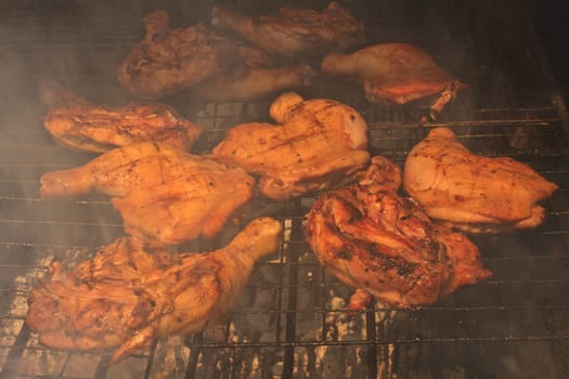 Grilled chicken thigh on the flaming grill