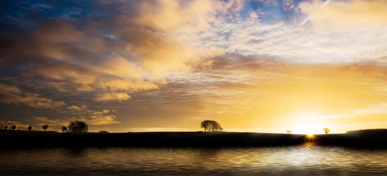 Beautiful sunrise across water with orange clouds