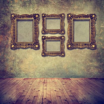 Vintage golden frames on grunge wall