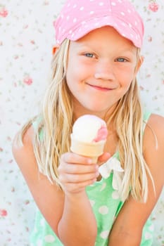 Cute smiling young girl holding ice cream cone