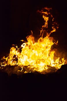 Flames and smoke fill this image of a ceremonial fire during a mayan ritual.