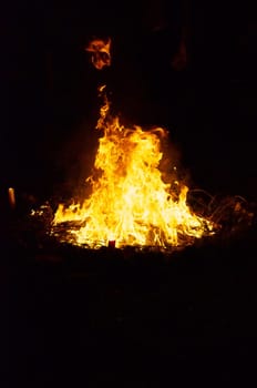 Flames and smoke fill this image of a ceremonial fire during a mayan ritual.