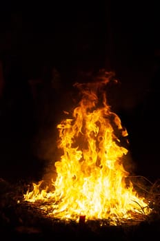 Flames and smoke fill this image of a ceremonial fire during a mayan ritual.