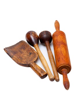 Old nostalgic wooden kitchen utensils insulated against a white background