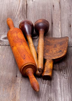 Old nostalgic kitchen utensils made of wood on rustic wooden surfaces