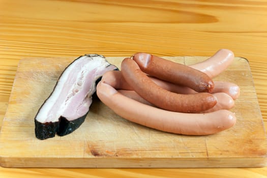 Detail of the smoked foods - bacon and hot dogs - junk food