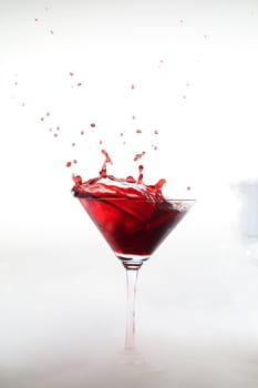 Vertical photo of a splash colored drink with smoke
