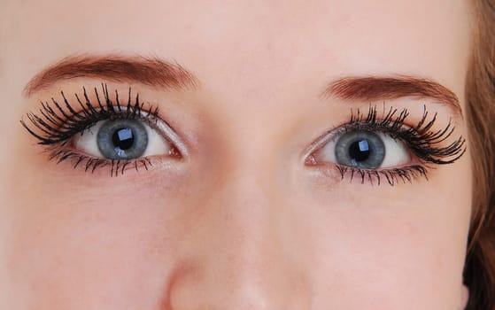 A closeup picture of the beautiful blue eyes of a young woman..
