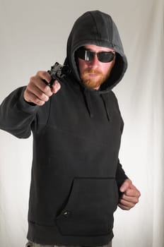 Black Dressed Young Man Holding a Pistol Gun