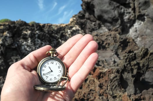 Time Concept Classic Vintage Pocket Clock on the Volcanic Rocks