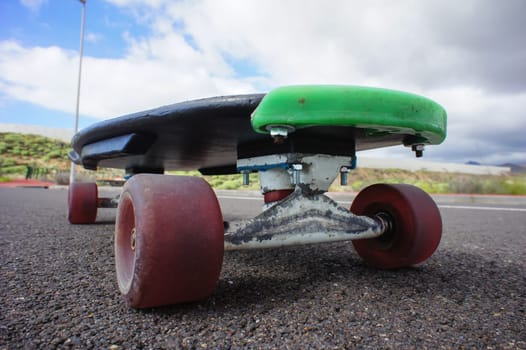 Vintage Style Longboard Black Skateboard on an Empty Asphalt Desert Road