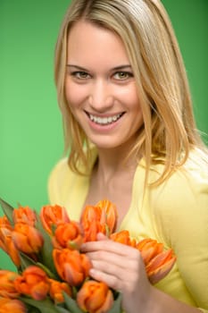 Smiling woman hold spring flowers bouquet of orange tulips