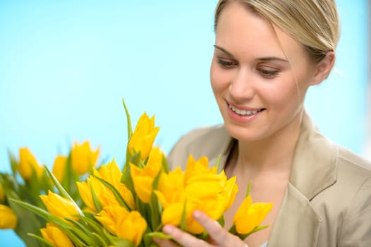 Woman looking down spring yellow flowers hold bouquet of tulip