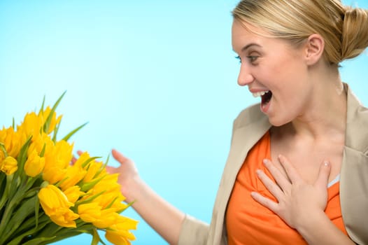 Surprised woman receive bouquet of yellow tulip flowers spring