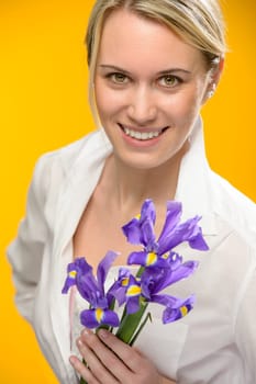 Smiling woman hold one blue iris spring flower smiling