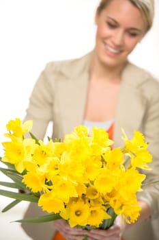 Bunch of yellow spring narcissus flowers smiling woman in background