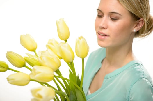 Woman looking down yellow tulip spring flowers isolated on white