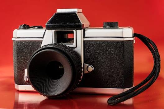 Classic 35mm Plastic Toy Photo Camera on a Colored Background