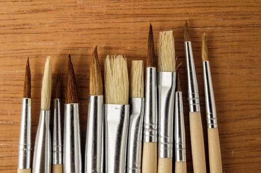 New Wooden Different Paintbrush Set Texture over a Colored Background