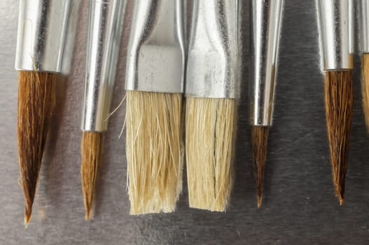 New Wooden Different Paintbrush Set Texture over a Colored Background