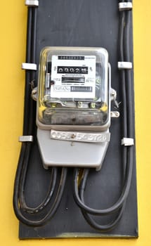 watthour meter on yellow wall