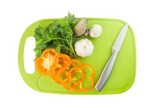 Pepper, Garlic, Parsley and mushroom on green Plastic board with knife on white background. with a clipping work path