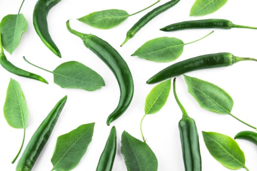 green hot chili pepper with leaves on a white background