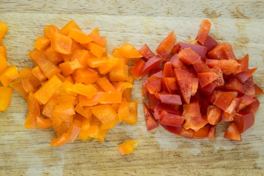 slices of colorful sweet bell pepper on wood board.