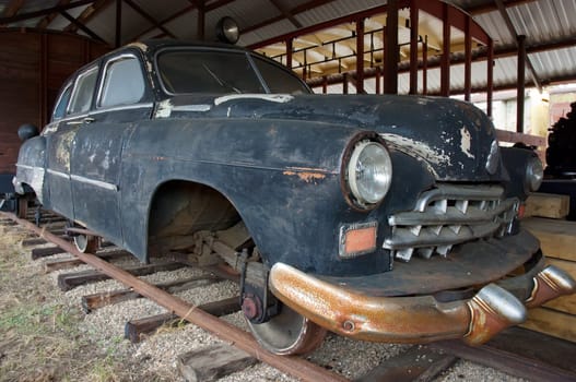 Old rusty car with trane weels. Made for traveling by railways