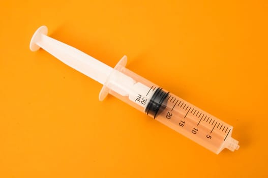 Big Black and White Syringe on a Colored Background