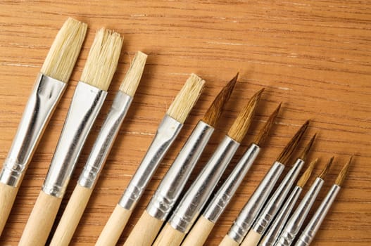 New Wooden Different Paintbrush Set Texture over a Colored Background