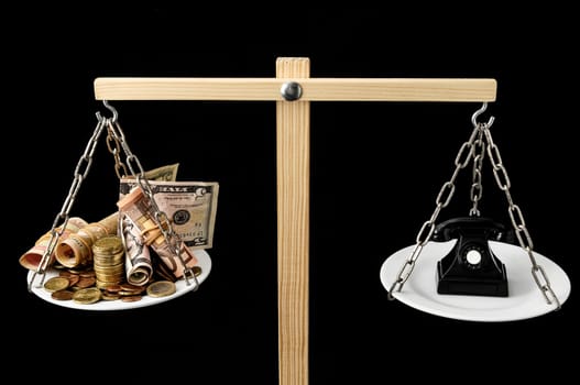 Money and Telephone on a Two Pan Balance