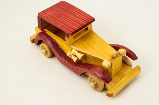 Wooden Toy Red and Yellow Car on a white Backgraund
