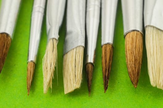 New Wooden Different Paintbrush Set Texture over a Colored Background