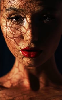 Reflection. Woman in Shadows with Reflection of Openwork Lace on her Face