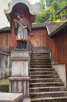 Old stairs in the historic center of Salzburg with the sacred statue (Austria)