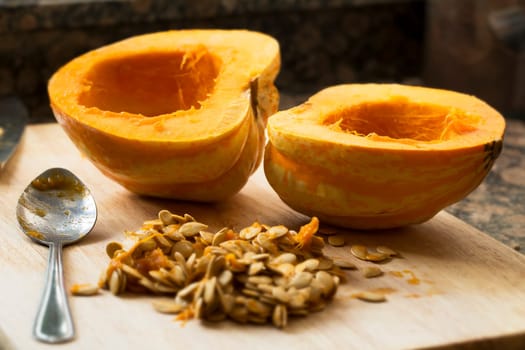 Winter squash cut in half with spoon and seeds scooped out.