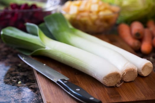 Leeks on cutting board with knife