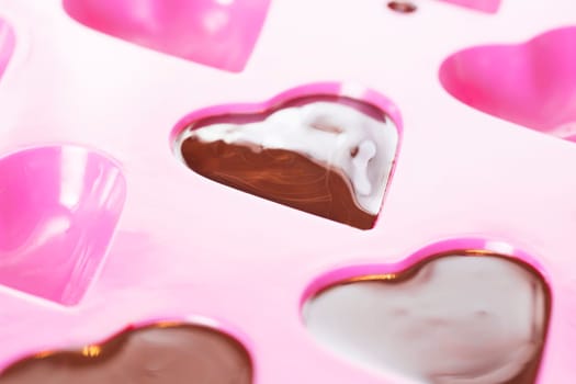 Close up of warm chocolate that has just been poured into a heart mould