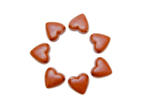 Chocolate hearts in a circle on white background