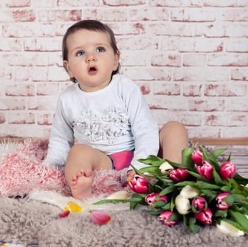 little girl surprised with tulip